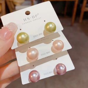 Close-up of pearl stud earrings with S925 silver needles in multiple colors