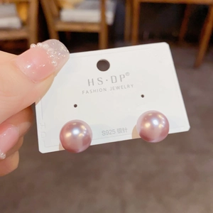 Close-up of elegant lavender pearl stud earrings with S925 sterling silver needles