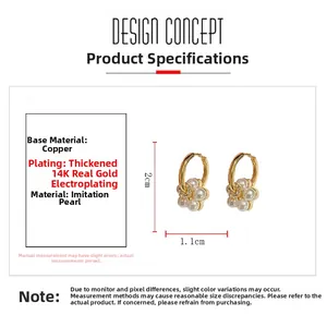 Detail view of 2cm gold flower earrings with white pearls and 14K gold plated copper base