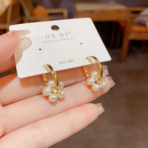 Elegant gold flower hoop earrings with white pearls and sparkling cubic zirconia crystals
