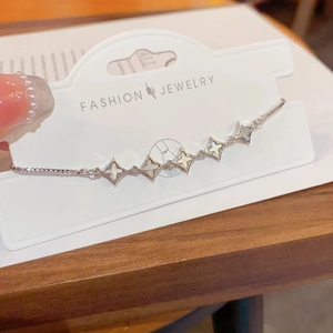 Adjustable silver star bracelet with iridescent shell inlay on white display card