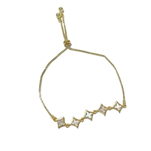 Adjustable gold star bracelet with iridescent shell inlay and bolo clasp closure