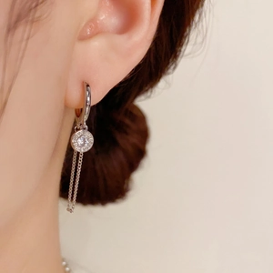 Silver drop hoop earrings with zircon pendant and double metal tassels on model