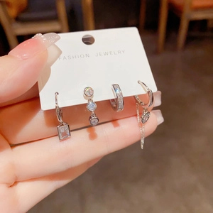 Silver-plated four-piece earring set featuring square cubic zirconia and dangling charms