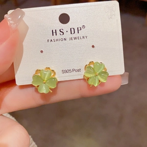 Detail of pink cat-eye stone clover earrings with S925 silver posts on display card