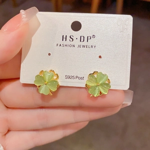 Detail view of S925 silver post pink cat-eye stone four-leaf clover earrings in gold plating