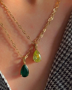 Close-up of double layer 18k gold plated necklace with emerald and yellow zircon drops