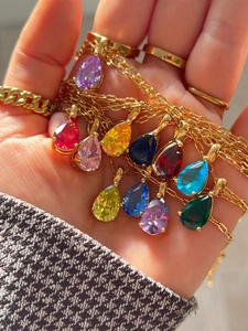 Detailed close-up of vibrant pear-cut gemstone necklaces in 18k gold-plated settings