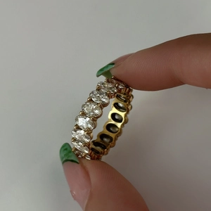 Detail view of 18k gold plated titanium ring with emerald cut zircon stone settings