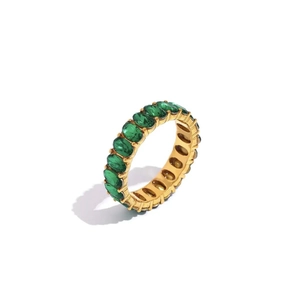 Detailed side view of a gold plated eternity ring with oval green cubic zirconia stones