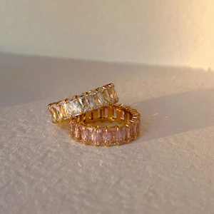 Detailed macro view of 18k gold plated eternity rings with baguette cut zircon stones