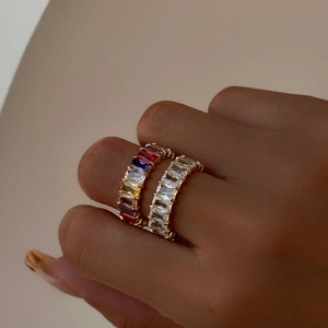 Detail of 18k gold plated eternity rings with colorful baguette cut zircon stones