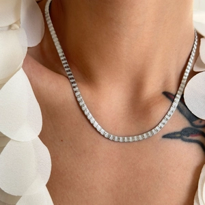 Detail of silver 4mm flat snake bone chain showing fine woven texture on a model