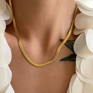 Detailed close-up of 4mm 18k gold plated flat snake chain necklace on silk background
