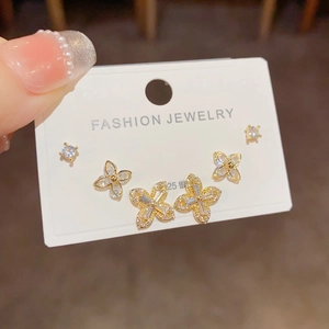Macro shot of gold four-leaf clover earrings set with micro-pave zircons and S925 silver pins