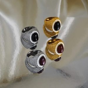 Macro detail of vintage 18k gold plated rings with colorful stones and enamel inlay