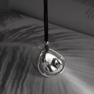 Minimalist silver fluid pendant necklace with black cord and mirror polished finish