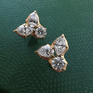 Macro view of 18K gold-plated stud earrings with pear and round-cut zircon clusters