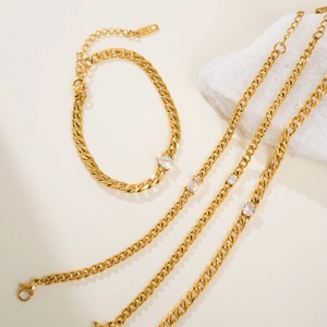 Detail of K18 gold plated Cuban chain set featuring teardrop zirconia crystals