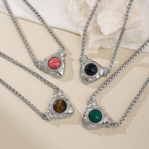 Macro detail of triangle stone pendants with silver woven chains in various gemstone colors