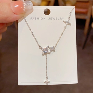 Macro detail of silver star pendant necklace with sparkling zircon star fringe