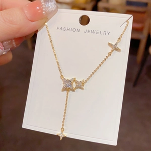 Detail of Y-shaped gold star tassel necklace with sparkling zircon star pendants