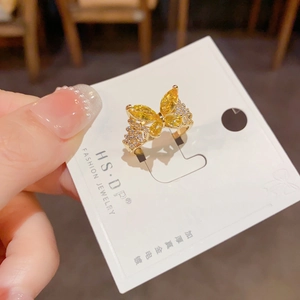 Detalle de un anillo mariposa de lujo con piedras marquise amarillas y circonitas brillantes