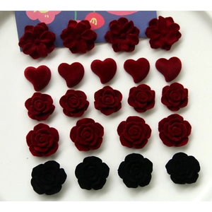 Detail of red and black flocked heart and rose acrylic charms for DIY jewelry making