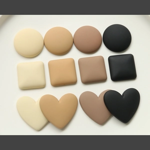 Macro detail of matte macaron heart and circle patches for DIY hair clip accessories