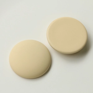 Macro shot of minimalist matte cream semi-circle charms for DIY jewelry and hair accessories
