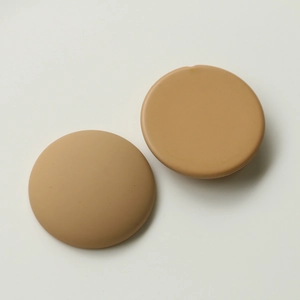 Detail view of skin-tone round silicone nipple covers with ultra-thin tapered edges