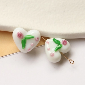DIY heart-shaped glass beads with delicate pink flowers and green leaves for jewelry making