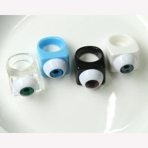 Macro shot of unique square resin rings featuring realistic eyeball iris art designs