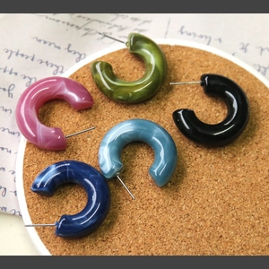 Detailed set of multi-colored C-shaped marble resin earrings with silver posts