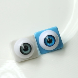 Macro shot of square resin rings featuring realistic blue eyeball designs and iris detail