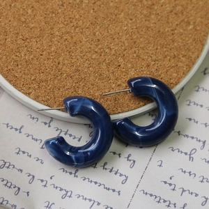 Detailed shot of dark blue marble texture C-shaped resin earrings with S925 silver needles