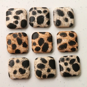 Detailed view of square leopard print buttons for DIY fashion accessories and coat decor