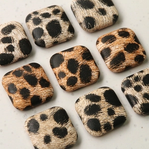 Square leopard print fabric buttons for coats and accessories in a diagonal arrangement