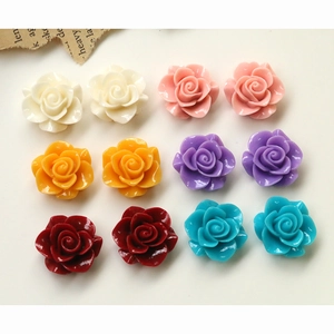 Flat lay of colorful resin camellia flower beads for DIY jewelry and hair accessories