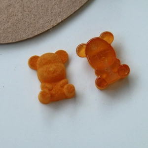 Detailed comparison of flocked and transparent orange bear charms for DIY jewelry and crafts