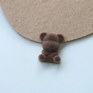 Detailed close-up of a brown flocked teddy bear acrylic DIY craft accessory for earrings
