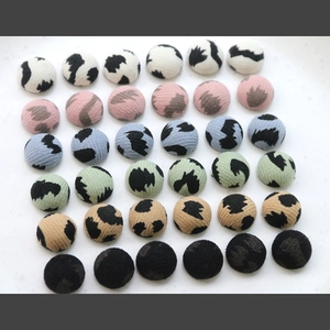 Detailed 6x6 matrix layout of various colored leopard print fabric covered buttons
