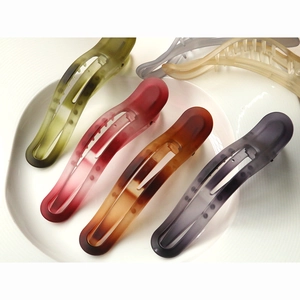 Close-up of matte banana hair clips in Morandi colors with hollowed streamline design