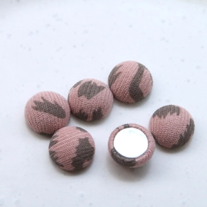 Detailed view of pink leopard print fabric buttons with flat metal back for DIY crafts