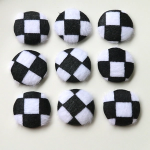 Detail of round black and white checkerboard plush faux fur DIY clothing accessories