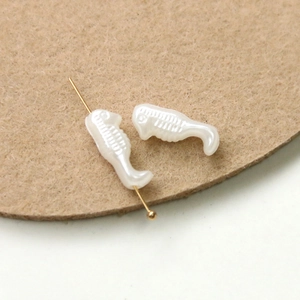 Detailed close-up of seahorse shaped pearl beads for DIY jewelry and craft making
