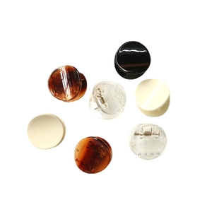 Set of small geometric resin hair claws in tortoise shell and cream on white background