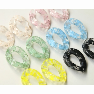 Detailed macro view of colorful droplet acrylic chain links with artistic ink splatter texture
