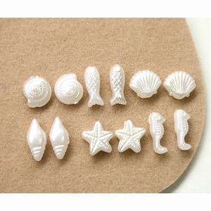 Pearlescent white marine themed beads set with starfish and shell shapes for DIY jewelry