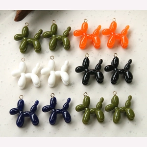 Macro shot of colorful resin balloon dog charms with metal rings for jewelry making